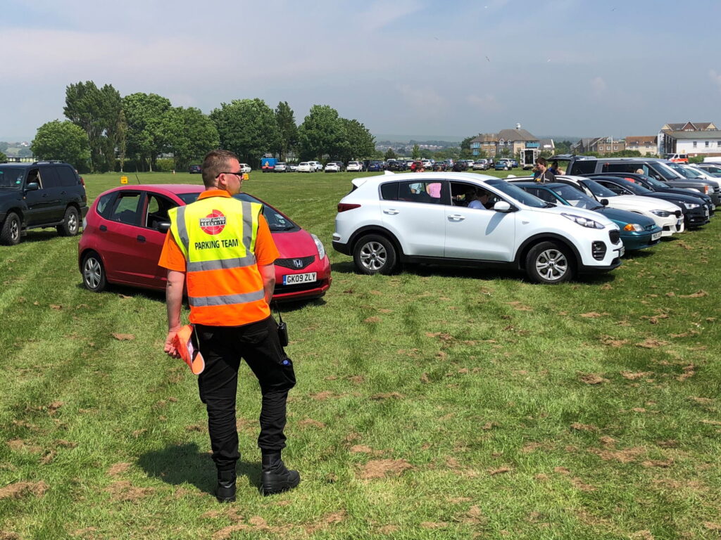 traffic control officer working at a green field parking
